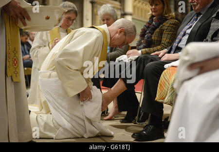 The Archbishop of Canterbury, The Most Reverend Justin Welby performs the Washing of the Feet ceremony during the Maundy Thursday Sung Eucharist service at Canterbury Cathedral, Kent. Stock Photo