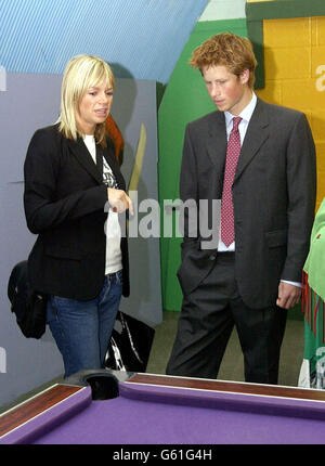 Prince Harry talks with radio and television presenter Zoe Ball at Kids Company, Peckham, South London, during a visit. Stock Photo