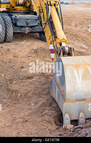 Wheel loader excavator with backhoe at construction site Stock Photo