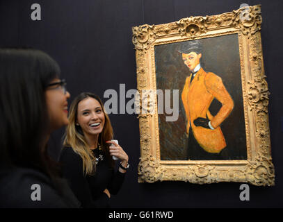 Alina Uspenskaya (centre) smiles while viewing Amedeo Modigliani's 1909 painting L'Amazone, as displayed at Sotheby's auction house during the preview for New York Auctions of Impressionist, Modern and Contemporary Art At Sotheby's London. One quarter of a billion dollars of art will be auctioned by Sotheby's in New York on 7th -8th & 14th-15 May 2013. Stock Photo