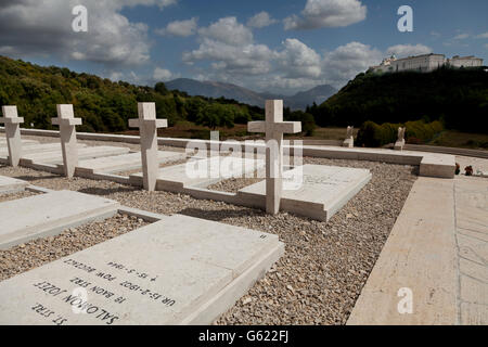 Gravestones on the Polish Cemetery and Monte Cassino Abbey on the mountain in the distance, Cassino, Lazio, Italy, Europe Stock Photo