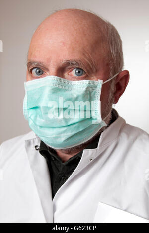 Doctor, physician wearing a white coat and a medical face mask Stock Photo