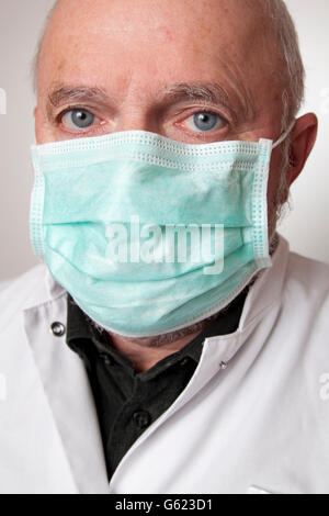 Doctor, physician wearing a white coat and a medical face mask Stock Photo