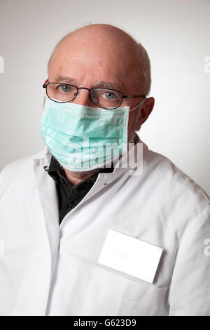 Doctor, physician wearing a white coat and a medical face mask Stock Photo