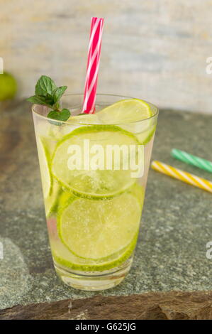 Cold green lime juice with ice cubes for a hot summer day Stock Photo