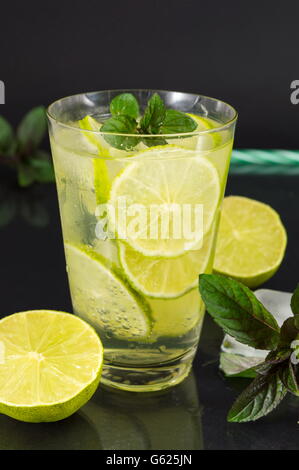 Cold green lime juice with ice cubes for a hot summer day Stock Photo