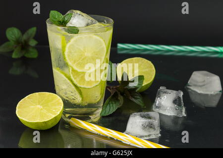 Cold green lime juice with ice cubes for a hot summer day Stock Photo