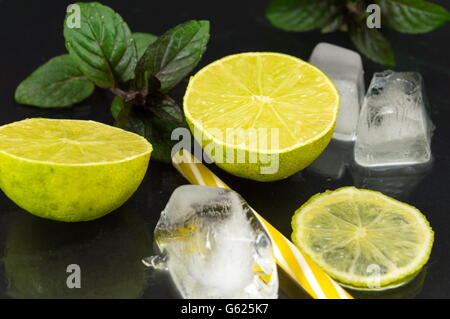 Cold green lime fruit with ice cubes ready for coktail making Stock Photo