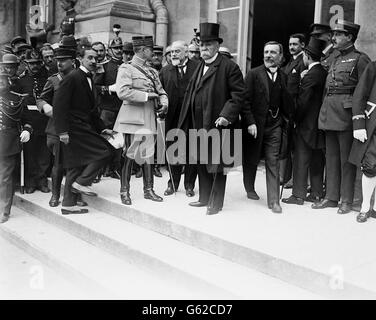 The French Prime Minister, Georges Clemenceau,(centre with top hat) leaving the Chateau at Versailles after the Peace Treaty had been signed. Stock Photo