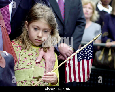 A young girl stands with an American stars and stripes flag outside St Paul's Cathedral in the City of London. White rose petals representing those who died in terrorist attacks on New York, Washington and Pennsylvania were released from the Whispering Gallery. *....... of St Paul's Cathedral during the service of Remembrance and Commemoration. Afterwards, the Prince of Wales and Prince Harry met relatives of the 67 British victims. Stock Photo