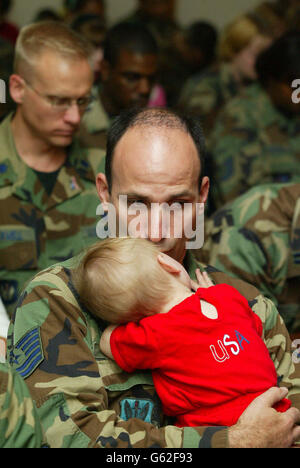 An American Solidier kisses his baby's head he reflects during a service remembering the victims of the terrorist attack on the Twin Towers, NewYork, at the Largest American Airbase in Europe, RAF Lakenheath in Suffolk. Stock Photo
