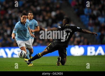 Soccer - Barclays Premier League - Manchester City v Wigan Athletic - Etihad Stadium. Manchester City's Samir Nasri (left) and Wigan Athletic's Maynor Figueroa (right) battle for the ball Stock Photo