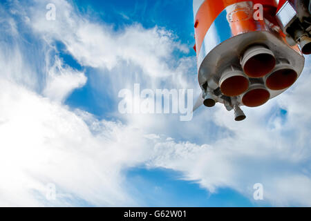 Space rocket engine nozzles against the bright moody sky with copy-space on it Stock Photo