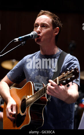 Singer Roddy Frame performs on stage during a soundcheck at The Royal Festival Hall in London prior to taking part in a tribute concert to singer/songwriter Kirsty MacColl. Stock Photo