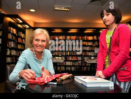 Mary Berry signs a copy of her book 'At Home' for a young fan, at a book signing session in a Waterstone's Book shop in Kensington, west London. Stock Photo