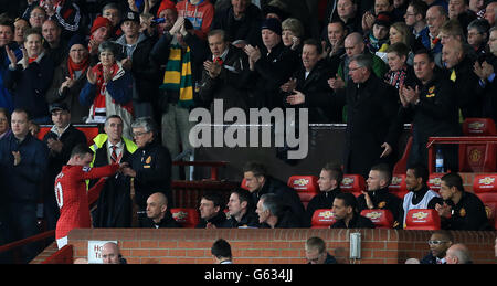 Manchester United's manager Sir Alex Ferguson (right) gestures to Wayne Rooney (left) as the player is substituted Stock Photo