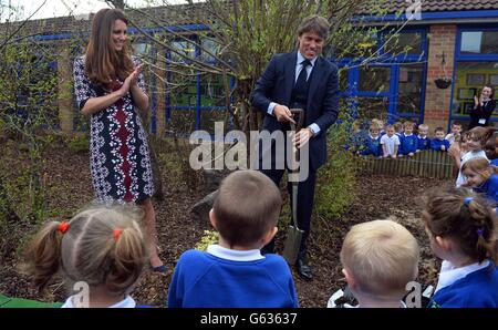 The Duchess of Cambridge plants a willow tree with comedian John Bishop at The Willows Primary School, Wythenshawe, Manchester where she launched a new school counselling programme to help combat the effects of drug and alcohol addiction. Stock Photo