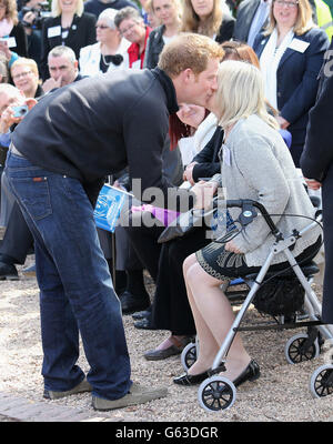 Prince Harry kisses brain injury survivor Mary Dery as he opens the new headquarters of Headway, the brain injury charity during an official visit to Nottingham. Stock Photo