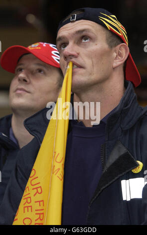 Firefighters Stuart Ruckledge (right) from Stockhill fire station in Nottinghamshire, and Matt Lee from Derbyshire, wait anxiously for news about the ongoing rounds of talks in the firefighters pay dispute, outside the New Connaught Rooms, London. * The Fire Brigades Union is currently negotiating with the Government for a proposed pay rise, after suspending earlier industrial action. Stock Photo