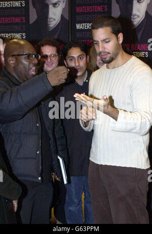 A member of the public reacts as a needle is pulled out of American Magician David Blaine's hand prior to book signing at Waterstones in London's Piccadilly to sign copies of his new book 'Mysterious Stranger'. Stock Photo