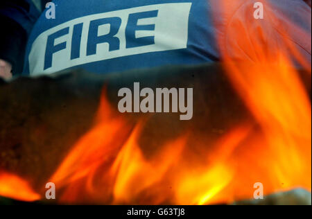 A firefighter turns his back on a burning oil drum on a picket line in Manchester on the day that Prime Minister Tony Blair addressed the nation on the ongoing pay dispute. 14/07/2004 Talks aimed at averting a fresh wave of strikes by firefighters in a long running row over pay will start with a new timetable set for walkouts if negotiations break down. The Fire Brigades Union said the meeting with fire authority employers would be a last ditch attempt to rescue a pay deal worked out after a series of stoppages in 2002 and 2003. Stock Photo