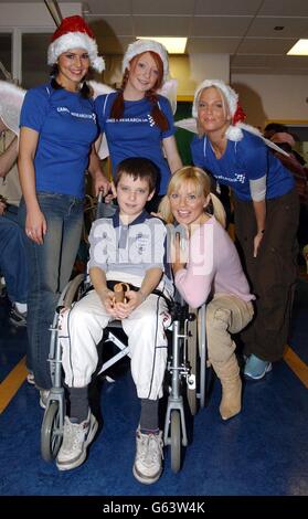 Pop singer Geri Halliwell and Popstars - The Rivals girls from left to right; Cheryl Tweedy, Nicola Roberts and Sarah Harding meet Robbie Kemp, 12, from Islington in London on behalf of Cancer Research UK. * The girls were at the Carousel Ward to give out Christmas presents on the Children's Cancer ward of the Middlesex Hospital during the launch of Children's Cancer Awareness Month, which runs throughout December. Stock Photo