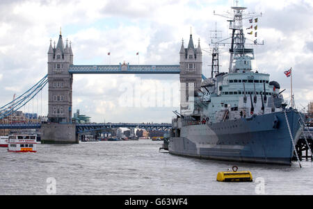 A general view the warship HMS Belfast in front of Tower Bridge on the River Thames, London. Stock Photo