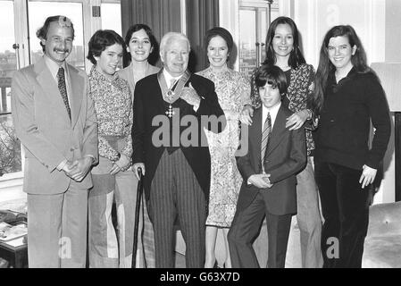Sir Charlie Chaplin is back in his suite at the Savoy Hotel, after being knighted at the Palace, with his family. Behind him (l-r) His son-in-law Nick Sistovaris, daughters Annie and Josephine, wife Oona, son Christopher and daughters Geraldine and Jane. LUKEOTDI: Charlie Chaplin, the legend of silent film, became Sir Charles after a ceremony at Buckingham Palace. Chaplin starred in pictures such as The Kid and The Great Dictator, and was knighted in the New Year's Honours List. Stock Photo