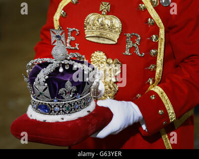 The Imperial State Crown is carried on a cushion as it arrives for the State Opening of Parliament, at the Houses of Parliament in London. Stock Photo