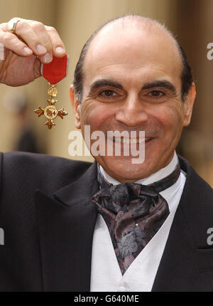 Actor David Suchet with the medal for civil division officer of the Most Excellent Order of The British Empire that he was awarded at Investitures at Buckingham Palace. The Queen admitted she was a David Suchet fan as she awarded the Hercule Poirot actor an OBE. Stock Photo