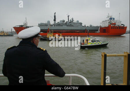 The Royal Navy ship HMS Nottingham arrives in Portsmouth on the back of Dutch heavy lifting ship MV Swan . The battered vessel has been brought back for 26 million of repairs after it sustained hull damage when it ran aground off Australia earlier this year. *..The Type-42 destroyer hit rocks and holed her hull from bow to bridge at Lord Howe Island in July. Stock Photo