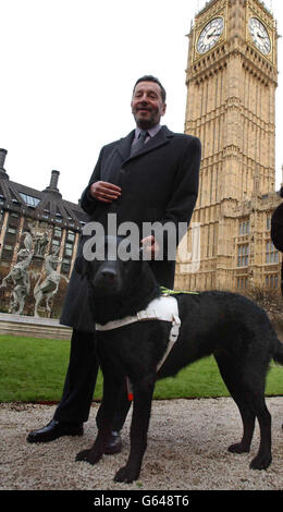 Home Secretary David Blunkett introduces his new guide dog Sadie to the media during a photocall at New Palace Yard, Palace of Westminster in London. After almost a decade as his constant companion, David Blunkett's beloved dog Lucy is retiring this weekend. * She will be replaced by her half sister Sadie - a two-year-old black Labrador-curly-coated retriever cross. Stock Photo
