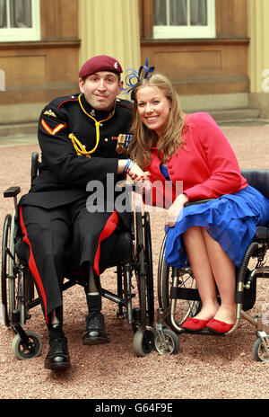 Lance Bombardier Benjamin Parkinson, Royal Artillery and Paralympian Hannah Cockroft after receiving their Member of the British Empire (MBE) medals from the Prince of Wales at an Investiture ceremony at Buckingham Palace, central London. Stock Photo