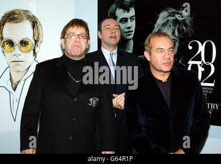 Sir Elton John (left), Kevin Spacey (centre) and Elton's songwriting partner Bernie Taupin pose for photographers as they arrive at the Music Industry Trust's Awards and Dinner 2002 at Le Meridien Grosvenor House, Park Lane in London. * Elton and Bernie are to be honoured at the 11th annual awards presentation organised by the British Phonographic Industry (BPI). Stock Photo