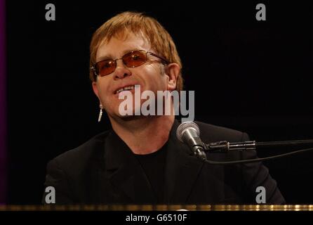 Sir Elton John performing on stage at the Royal Opera House in Covent Garden. 27/11/03: The singer is to perform some of his biggest hits with a choir and 108-piece orchestra for a pair of arena shows next summer, it was announced. The flamboyant star will be joined by his regular band as well as the Royal Academy of Music's orchestra and choir. Stock Photo