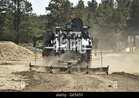 A Terrier armoured digger in the mine clearance role, which is entirely controlled remotely during an unveilling at the Defence Armoured Vehicle Centre, Bovington, Dorset. Stock Photo