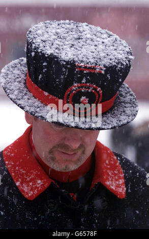 Yeoman Warder, Simon Dodd, outside the Tower of London, as a band of hit and miss snow showers hit eastern parts of the UK. During a night of heavy frost, temperatures sank as low as minus 8C in Farnborough, Hampshire. * ... and Hawarden in north east Wales and plunged to minus 16C in the Highland town of Aviemore. Stock Photo