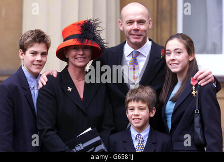 England Rugby Union manager Clive Woodward (centre) with his family after receiving his OBE from the Queen, outside Buckingham Palace. * They are (from left to right): Joe, 14, wife Jayne, Freddie, 8, and Jess, 16. Under Woodward, England have reached the top of the world rankings. Stock Photo