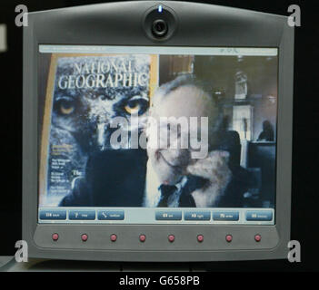 Gilbert Grosvenor, the great grandson of telephone inventor Alexander Graham Bell, talks on the latest video phone from his office at the National Geographic Society in Washington DC. *Mr Grosvenor made the hi-tech link using the mm745 to Graham Brown, Managing Director of Motion Media in Aust near Bristol 126 years after his famous relative patented his invention. Stock Photo
