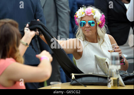 Racegoers in the Lonsdale Enclosure during The Investec Ladies Day at Epsom Downs Racecourse, Surrey. Stock Photo
