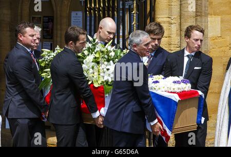 Gold medal winning sailors Sir Ben Ainslie (third left), Iain Percy (second from right) and Paul Goodison (right) carry the coffin of their close friend, Andrew 'Bart' Simpson, from Sherborne Abbey in Sherborne, Dorset. Stock Photo