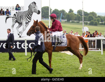 Horse Racing - The Investec Ladies Day - Epsom Downs Racecourse. The Lark ridden by jockey Jamie Spencer goes to post for the Investec Oaks Stock Photo