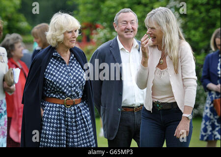 The Duchess of Cornwall with Pink Floyd drummer Nick Mason and his wife Annette during a visit to Middlewick House in Pickwick, Wiltshire, the home of Pink Floyd drummer Nick Mason, which is holding a charitable garden open day. Stock Photo