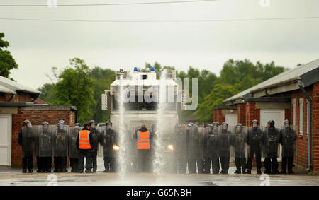 Police officers including members of the PSNI undergo riot training including the use of a water cannon at Longmoor Army Camp ahead of the G8 meeting in Northern Ireland. Stock Photo