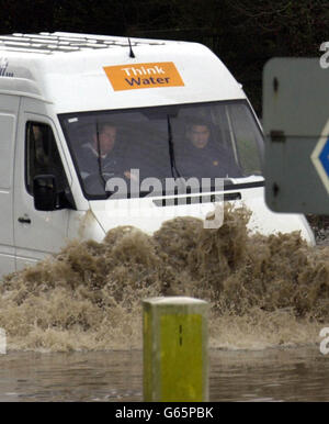 A van is driven through a large pool of water covering a slip road on the M50 motorway near Tewkesbury, as heavy rainfall continues to cause problems up and down the country. Stock Photo
