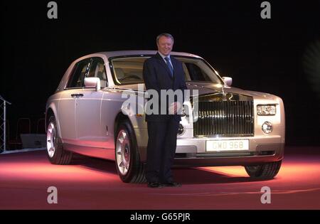 The Chief Executive and Chairman of Rolls Royce Tony Gott, with the all-new Rolls-Royce Phantom unveiled at the company's new manufacturing plant and head office at Goodwood in West Sussex, UK. * The car has a V12 engine taking it from 0-60 mph in 5.7 seconds (0-100 kph 5.9 seconds) and on to a limited top speed of 149 mph (240 kph). Elsewhere the electrically retractable Spirit of Ecstasy can be lowered out of sight whenever the Phantom is parked; the wheel hub centres, bearing the interlinked double-R logo, remain upright; and there are umbrellas stowed within each rear door. It is just Stock Photo