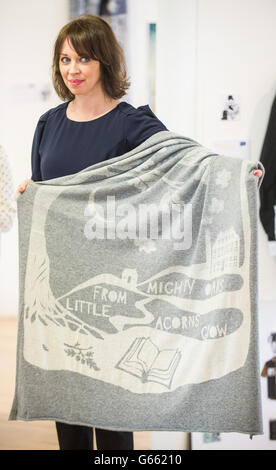 Lecturer Emily Quinn holds a blanket, which was given to the Prince of Wales and Duchess of Cornwall, made for their future grandchild and contains the quote 'from little acorns grow mighty oaks', during a visit to the School of Textile and Design at Heriot Watt University in Galashiels. Stock Photo