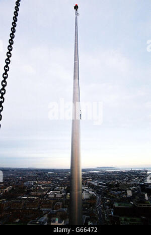 A unique view of Dublin, taken from a cradle suspended from Ireland's biggest crane, weighing a thousand tonnes, the day after it placed the final section of Dubin's 120 metre tall, 4.5 Million Euro, spire monument, outside the General Post Office on O'Connell Street. * .. watched by hundreds of Dubliners. 04/02/03 : Sinn Fein tonight called for the public to be given the choice in naming Dublin's newest and most imposing monument. They said there should either be a poll or a schools' competition to decide a formal identity for the 120-metre (393ft) spire that now dominates the skyline of the Stock Photo