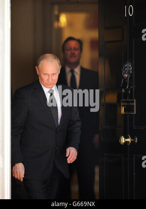 Prime Minister David Cameron watches as Russian President Vladimir Putin, leaves 10 Downing Street, London, following talks on the Syrian crisis. Stock Photo