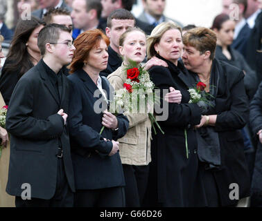 Relatives of murdered Ulster Defence Association commander John Gregg walk behind his coffin through the streets of Rathcoole on the outskirts of Belfast. * Gregg was being buried hours after relatives and friends of his bitter foe Johnny Mad Dog Adair were driven out of the city. Among thousands of mourners were the four remaining UDA brigadiers who had fought alongside Gregg in a deadly turf war against Adair. Stock Photo